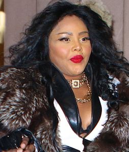 Lil Kim wears a big fur coat and fake eyelashes while out in NYC