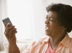 Senior African woman yelling at cell phone