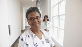 African American nurse in hospital hallway