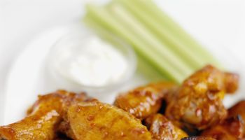 Close-up of buffalo chicken wings with dip and celery
