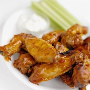 Close-up of buffalo chicken wings with dip and celery