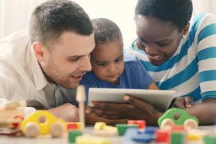 Mixed Race Family having fun with digital tablet.