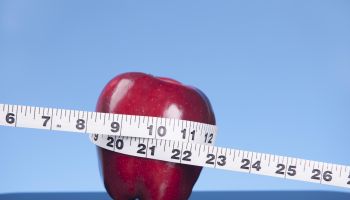 Tape measure and apple.