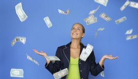 money falling around a businesswoman