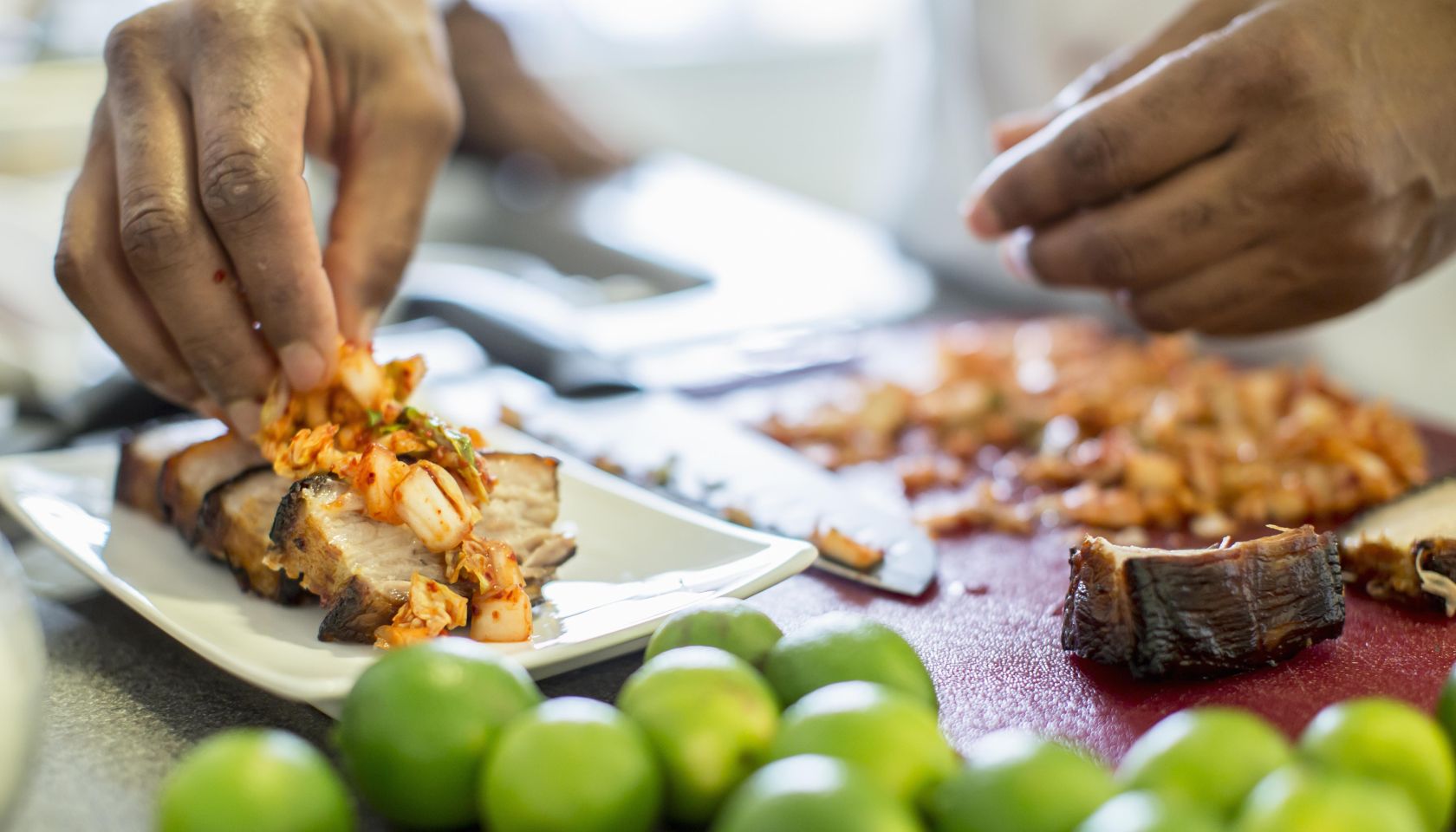 Black chef making pork belly and kimchee in restaurant