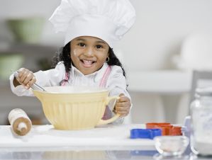 African girl mixing batter