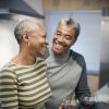 Couple laughing in kitchen together