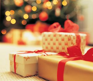 Close-Up of presents with Christmas Tree in background