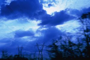 Cloudy sky with silhouetted power lines