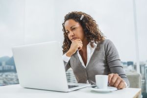 Pensive African American businesswoman using computer at office.