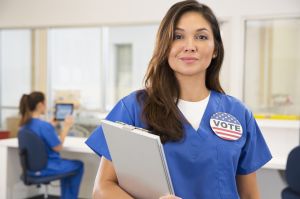 Nurse wearing Vote button in hospital
