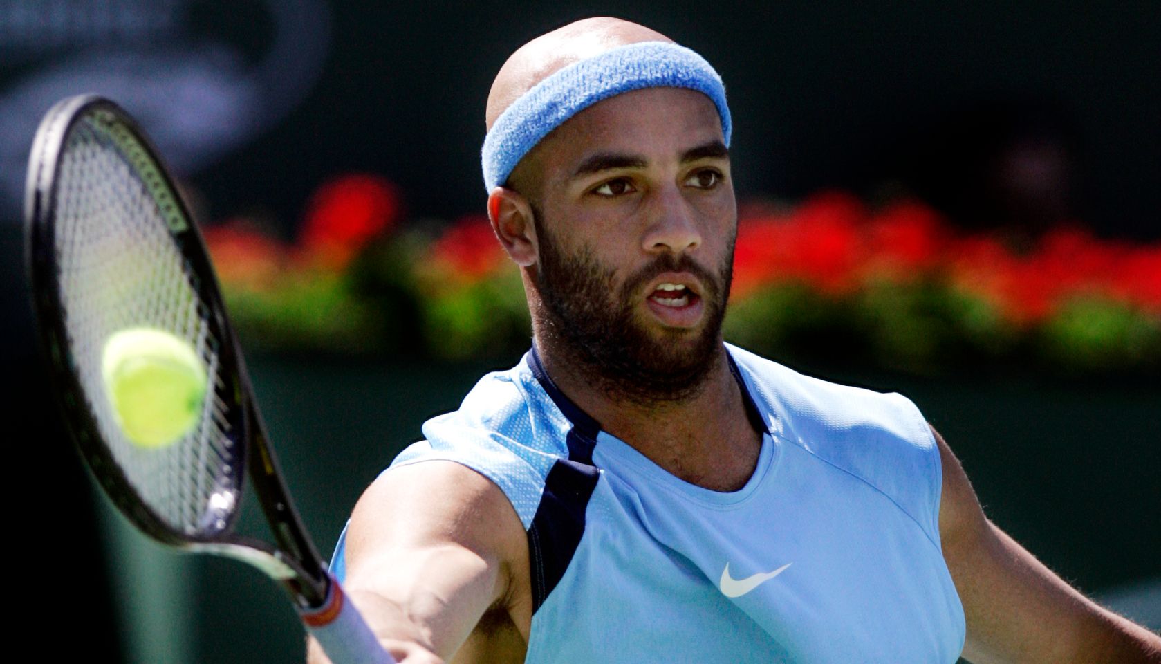 James Blake gets the ball right on the racket during a forehand shot against Roger Federer in the f