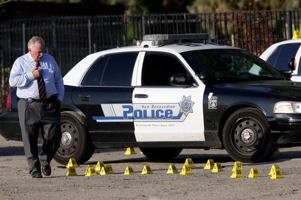 SAN BERNARDINO, CA. AUGUST 22, 2014 --- San Bernardino police investigators at the scene of an offic