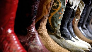 Row of cowboy boots in shoe store, full frame