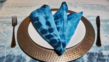 High Angle View Of Blue Napkin In Plate On Table