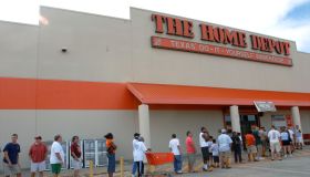 Residents of Houston, Tex., line up outside a Home Depot, on