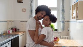 Morning love, couple in kitchen, looking at camera