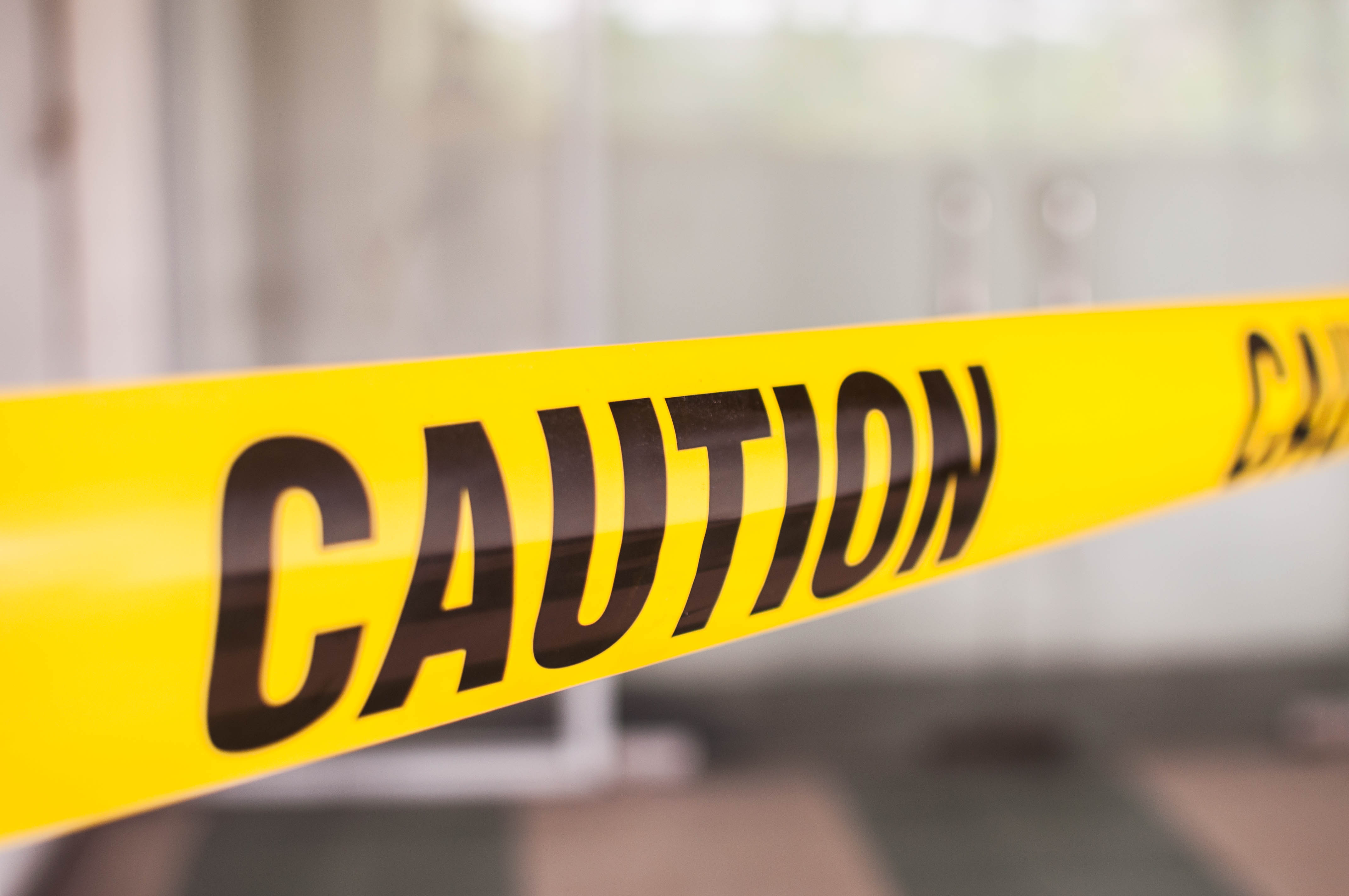 Yellow tape with caution sign