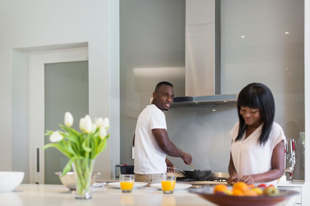 Couple preparing food in the kitchen, Cape Town, South Africa.