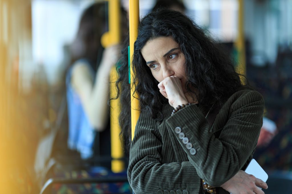Pensive woman traveling with public transport