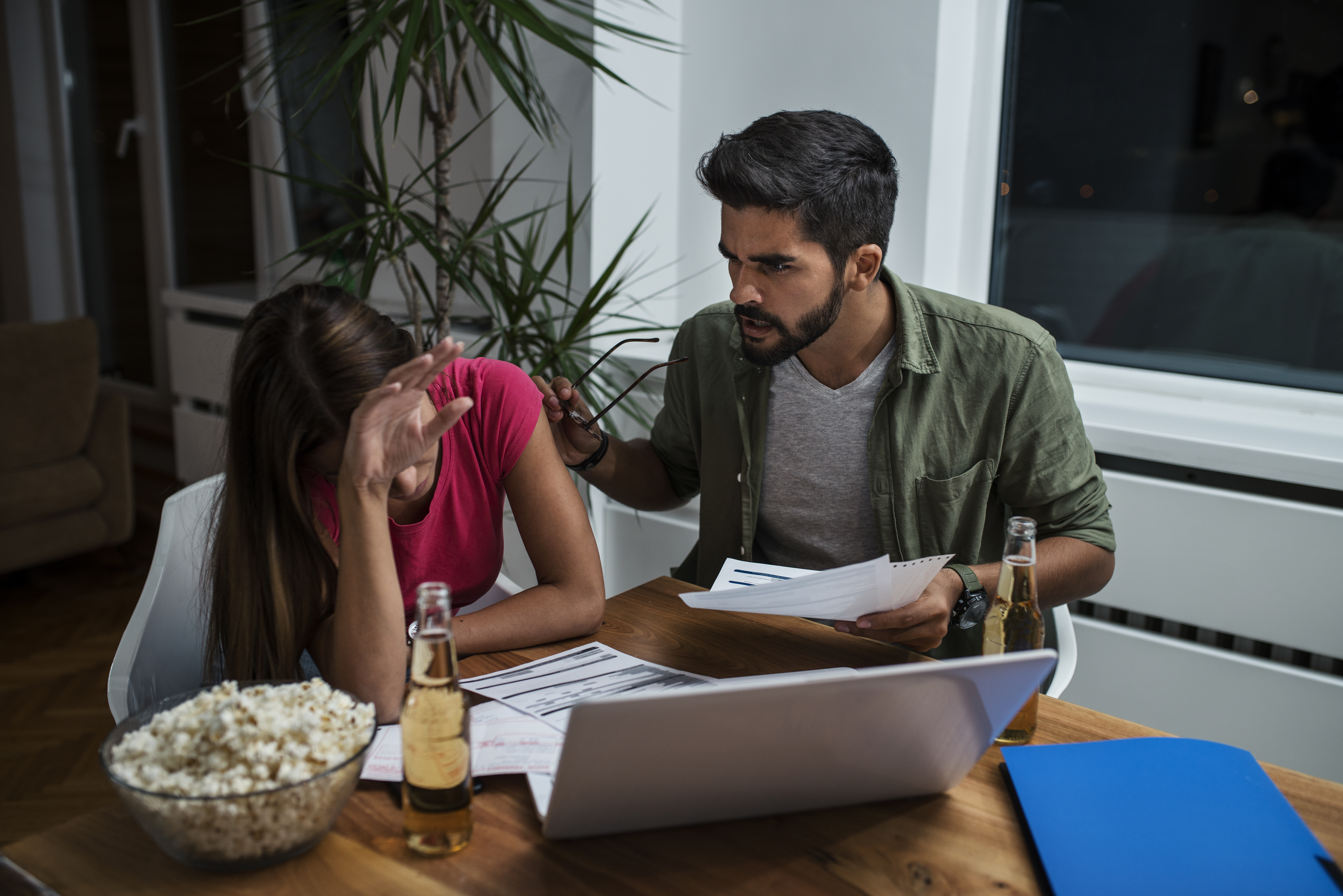 Worried young couple with financial bills