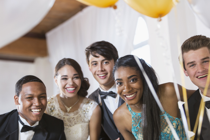 Five happy teenagers at formal party