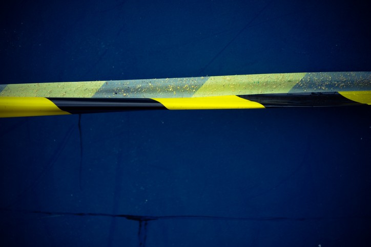 Close-Up Of Cordon Tape Against Blue Wall