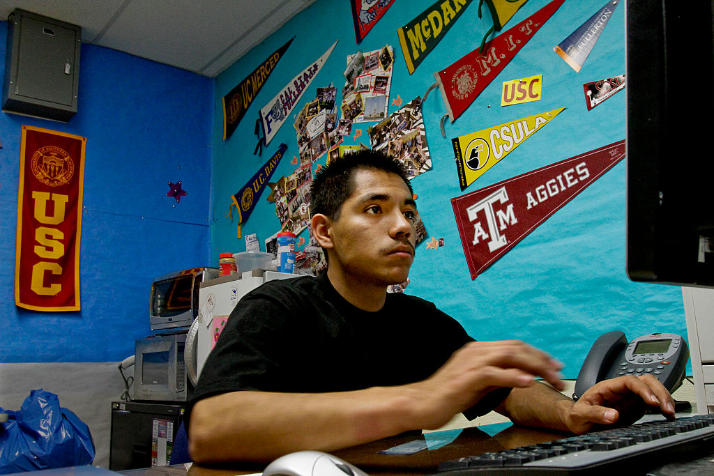 Edgar Flores-Villalobos (CQ), 18, fills out a form for a scholarship as seniors at Garfield High Sc