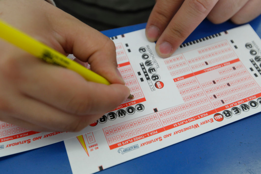 Randolph, MA - Nelson Reyes of Randolph fills out Powerball tickets for the first time at Butts & Bets in Randolph, Massachusetts on Saturday May 18 , 2013. Photo by Matthew Healey