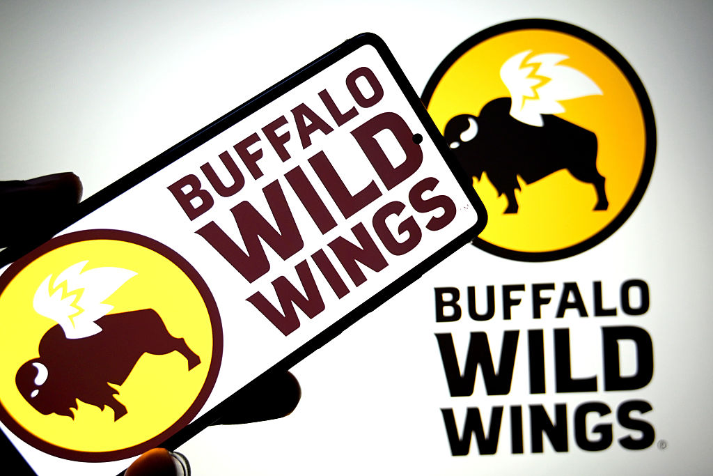 In this photo illustration, a Buffalo Wild Wings logo is...