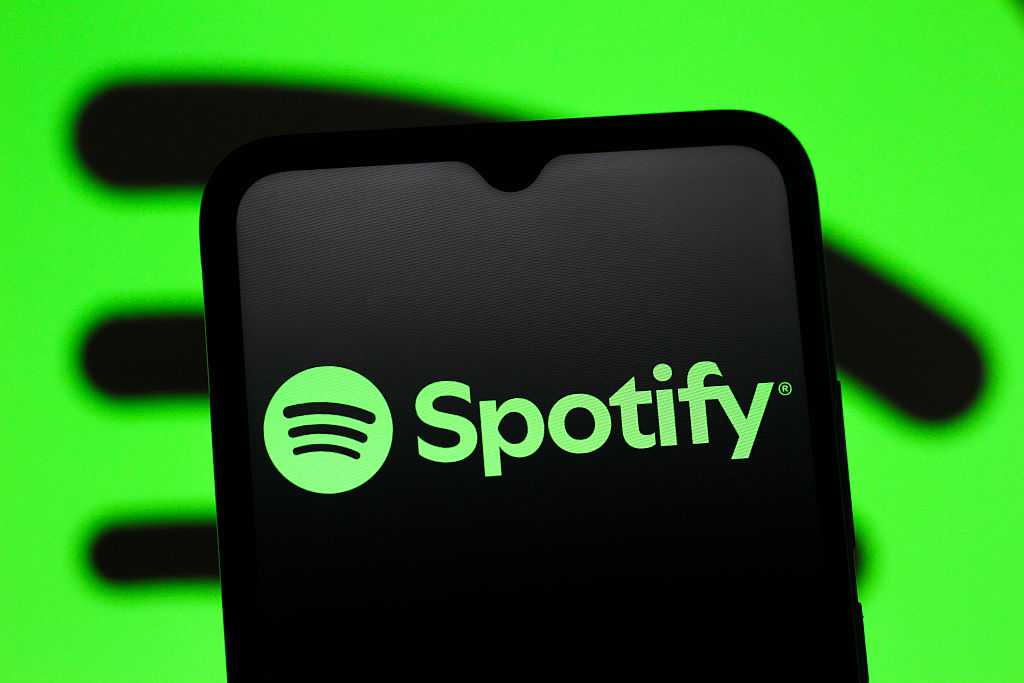 In this photo illustration, the Spotify logo is seen...