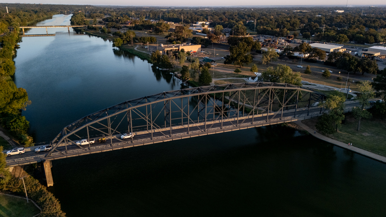 Aerial View of Historic Steel Truss Bridge Over the Brazos River in Waco Texas