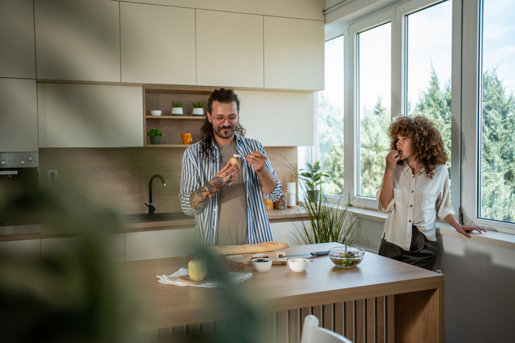 Couple preparing healthy meal in modern kitchen