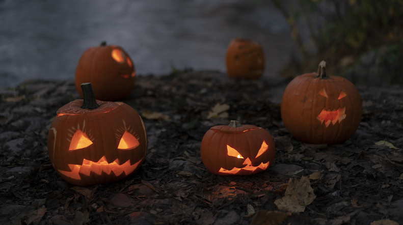 Glowing halloween pumpkins with scary carved faces