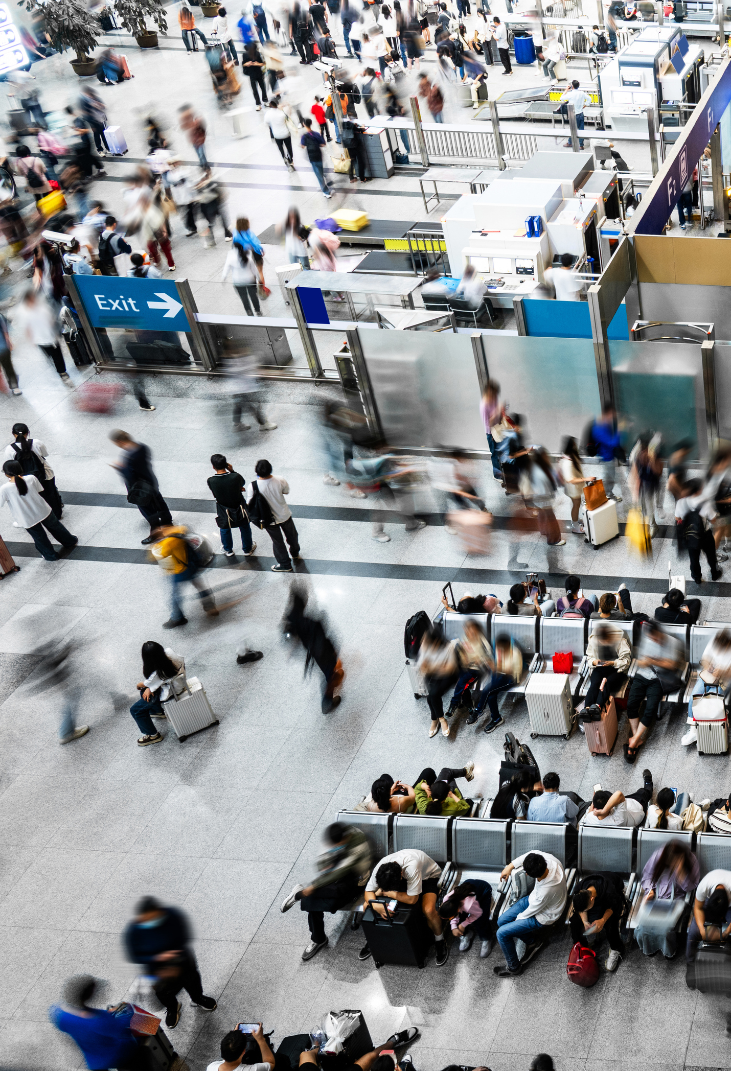 Top view of passengers walking or standing or sitting at railroad station