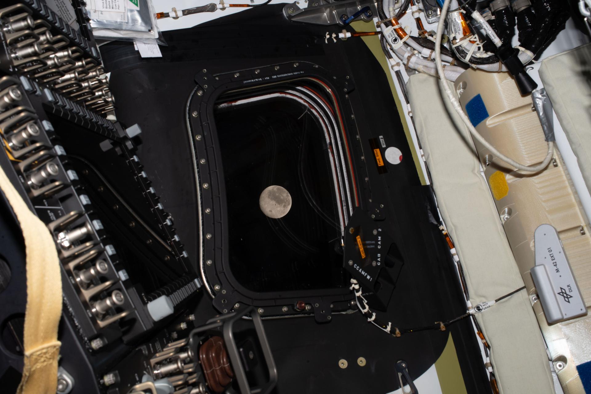A complex interior view of a spacecraft or satellite, with various mechanical components and wiring visible.