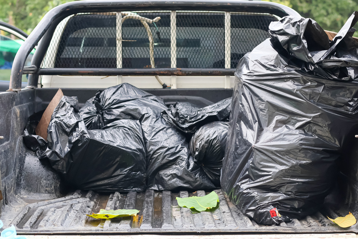 Black Trash Bags Loaded in Pickup Truck Bed.