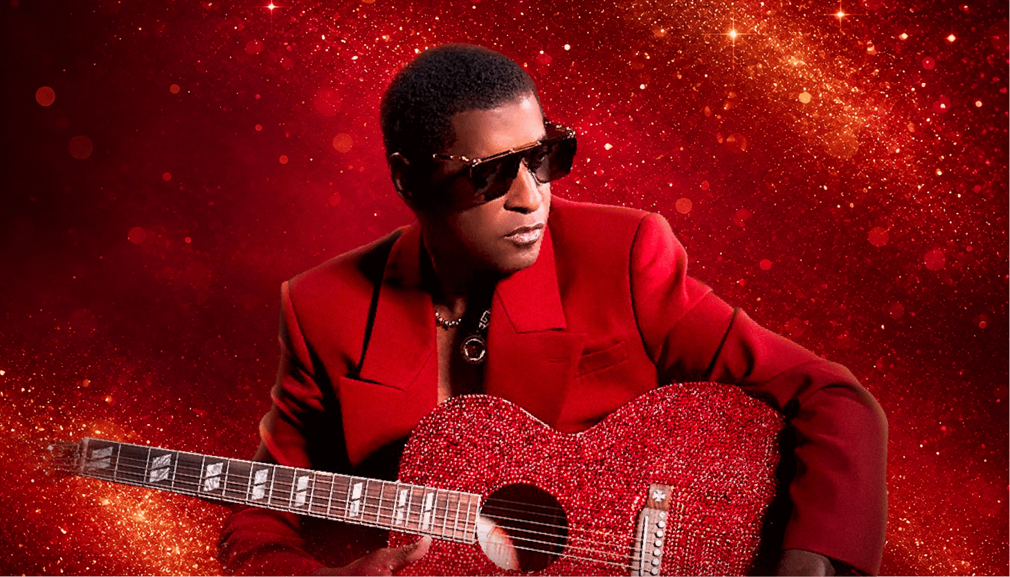 A person wearing a red suit and sunglasses playing a red guitar against a sparkling red background.