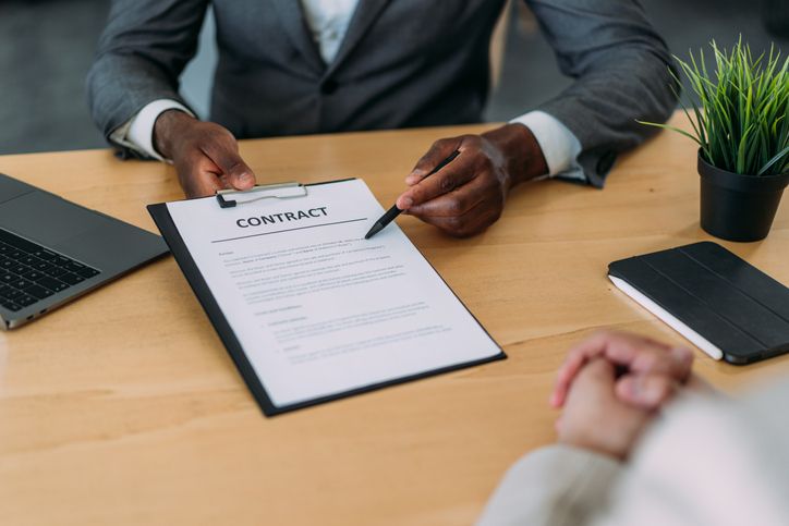 Business people signing a contract in the office.