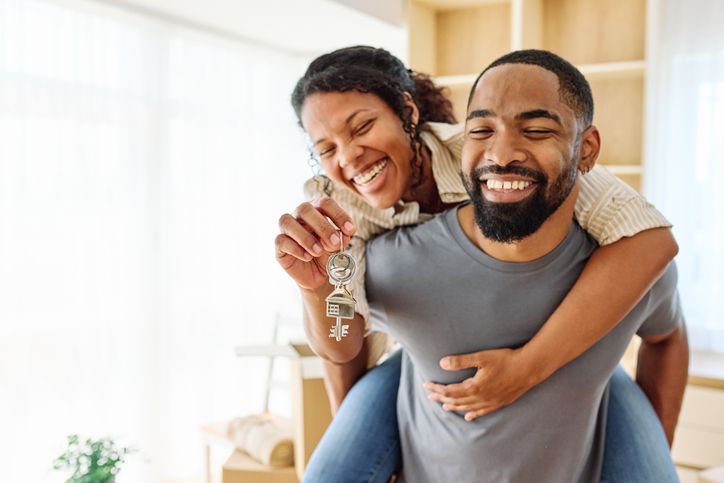 relocation woman man apartment house new couple home moving key investment homeowner owner holding buying purchase married