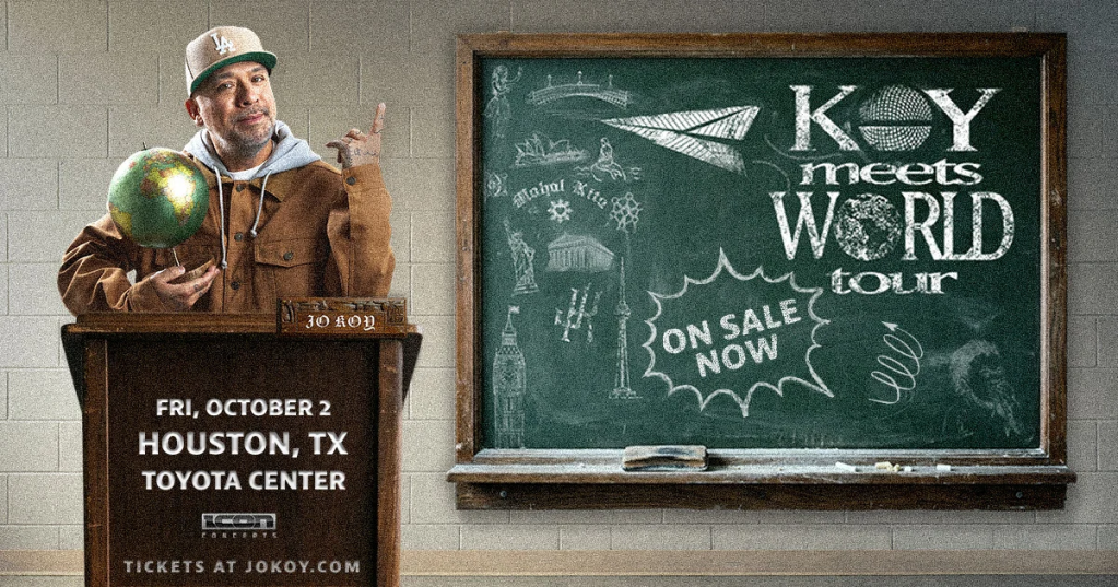 A man wearing a baseball cap stands in front of a chalkboard advertising a "Key meets World tour" concert on October 2 in Houston, TX.